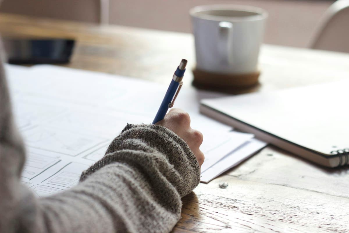 Person working through a readiness checklist at a desk with laptop and notes